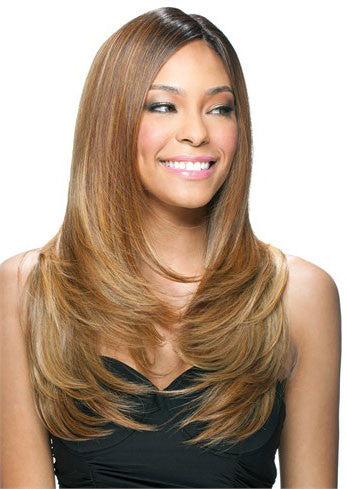 A woman with long, smooth, light brown hair styled in loose layers smiles while looking to the side.