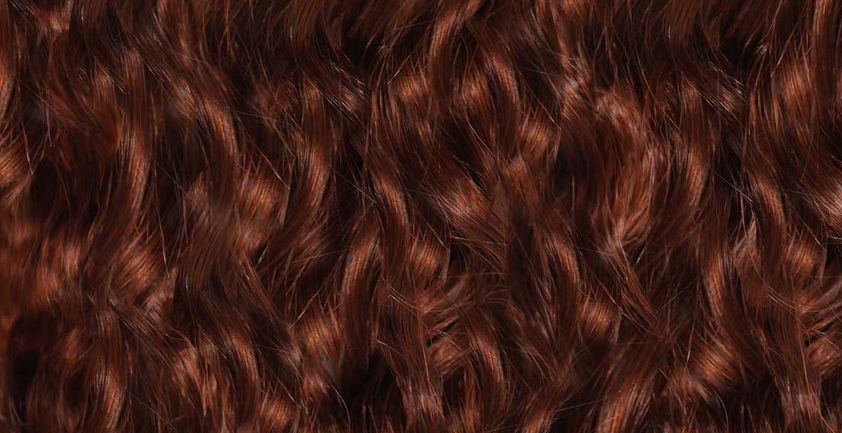 Perfect Locks red hair extensions with shiny, curly reddish-brown strands and vibrant highlights