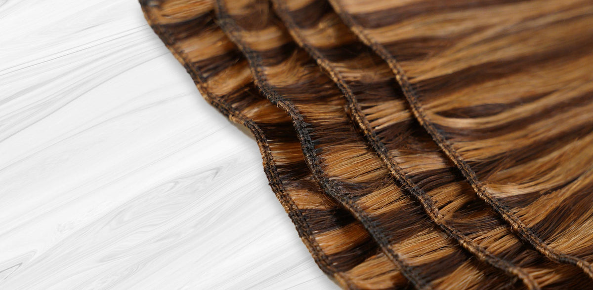 Perfect Locks hand-tied weft extensions in brown and blonde showing the seamless stitched weft