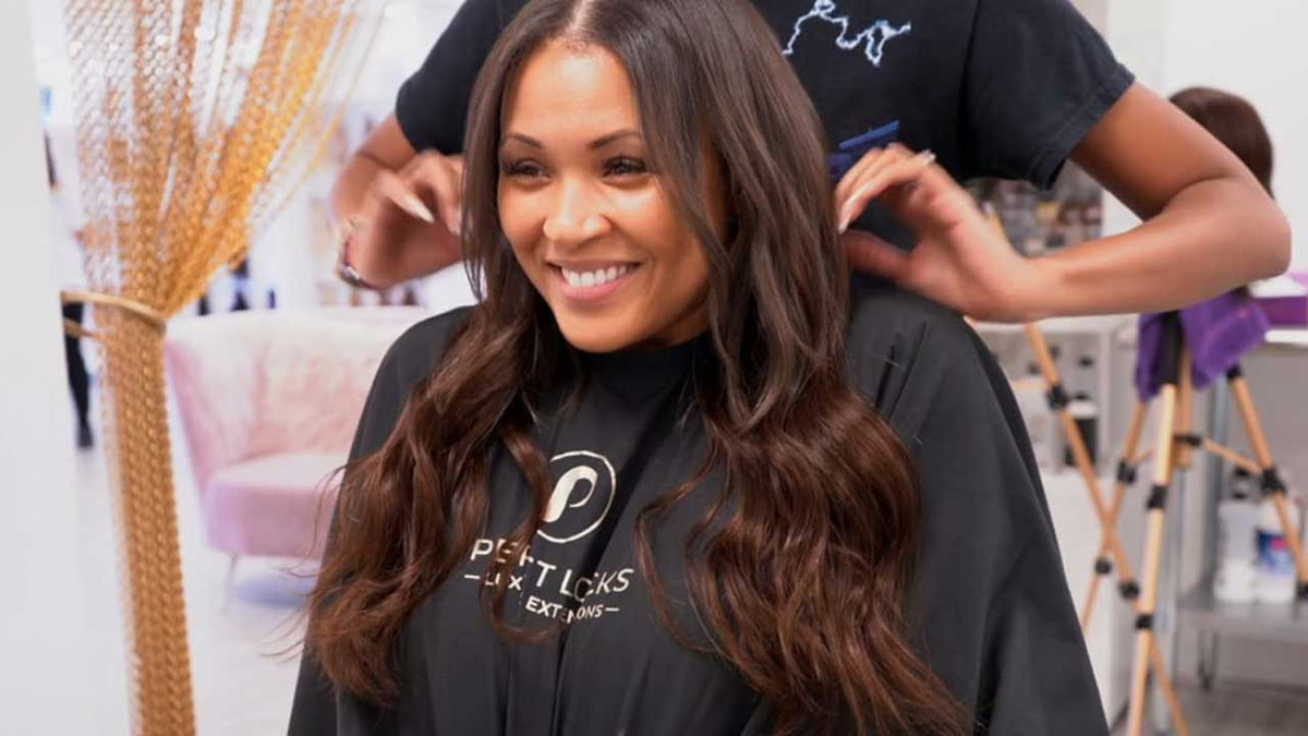 Woman with long, wavy dark brown Perfect Locks long wavy weaves in a shimmery brown top