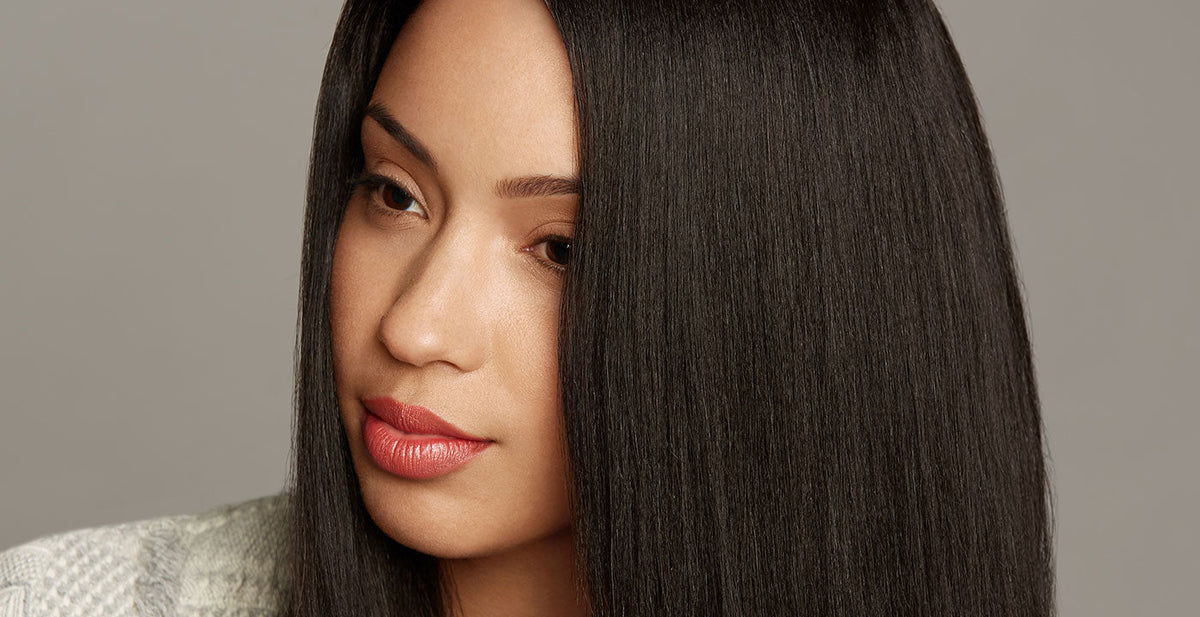 Woman wearing a Perfect Locks straight wig with smooth dark hair, calm expression, and light makeup