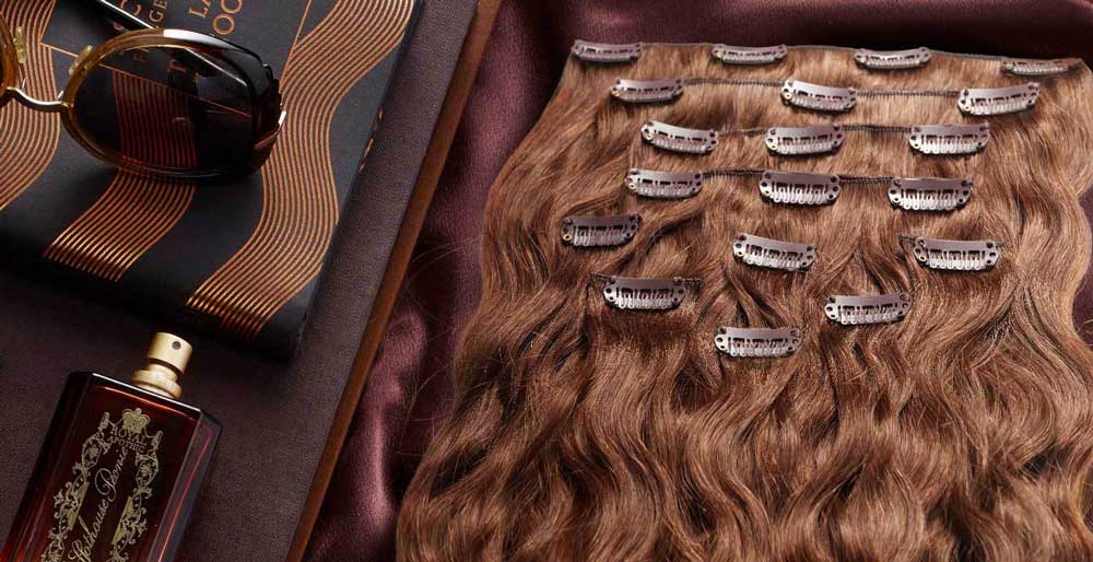 Perfect Locks ready-to-wear extensions in wavy brown displayed with styling accessories