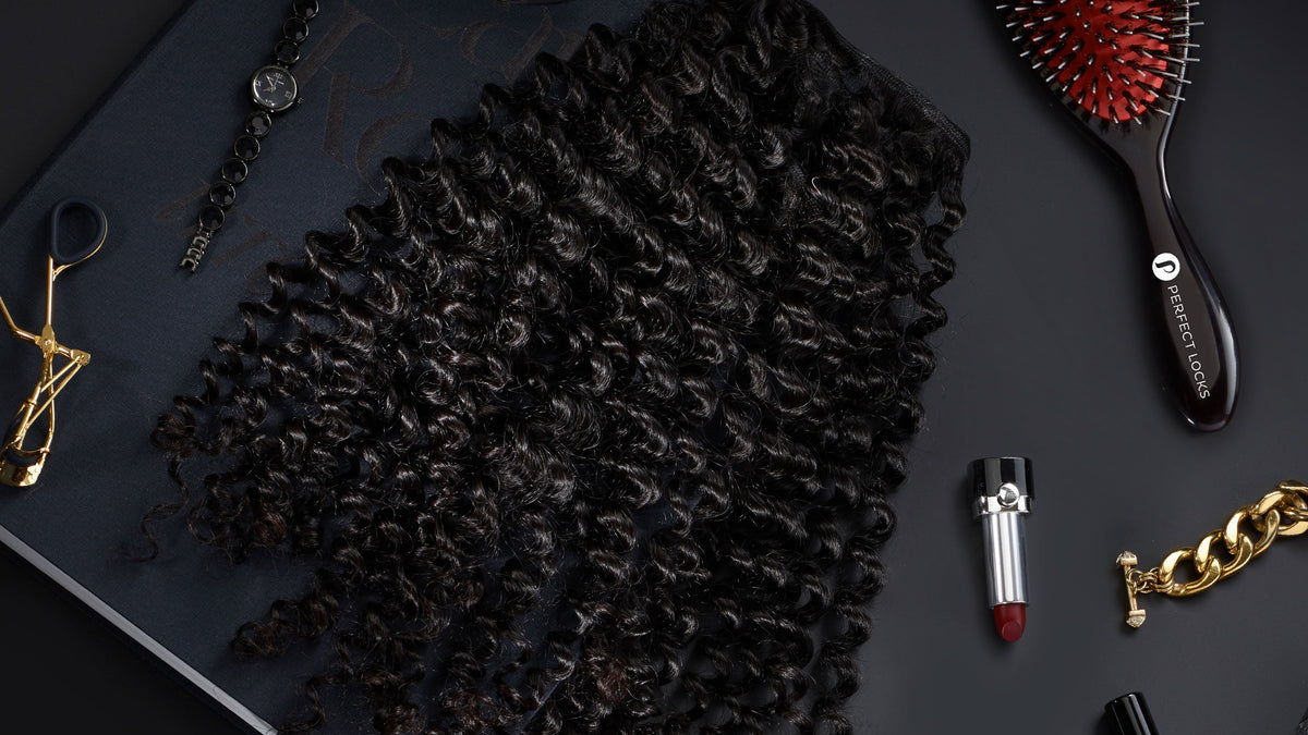 Perfect Locks virgin machine weft extensions on a dark surface with professional styling tools