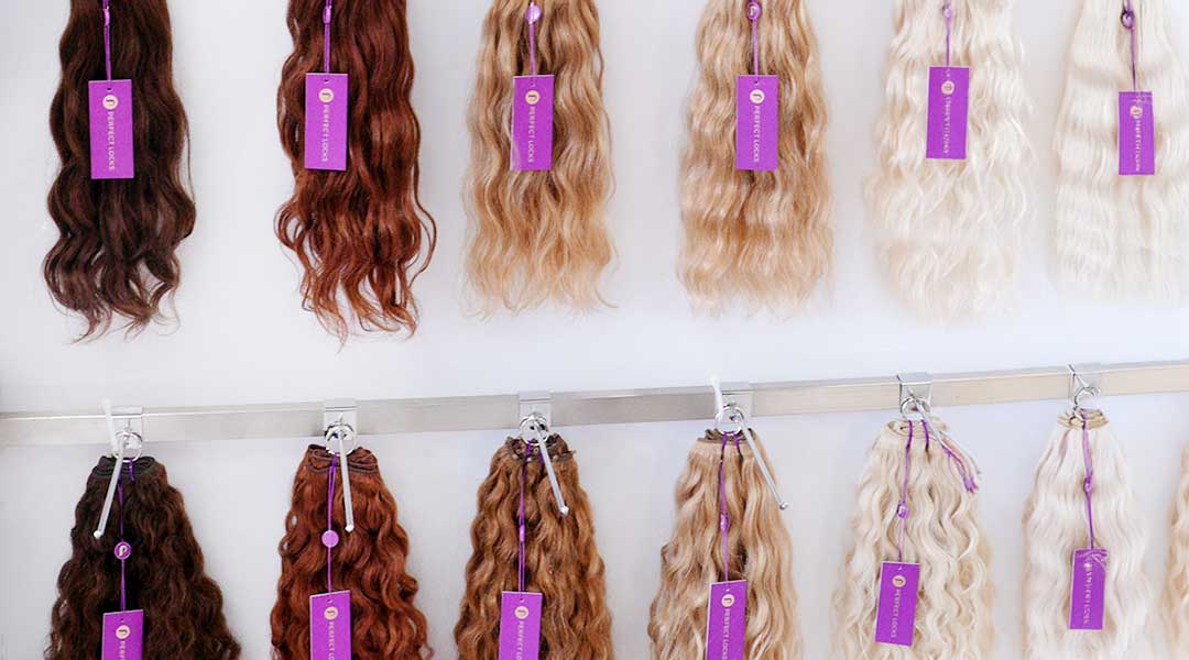 Perfect Locks clearance rack displaying hair extension strands in six vibrant color options