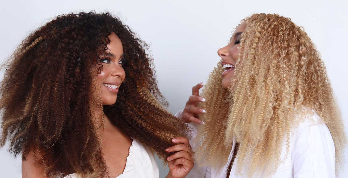 Two women in Perfect Locks textured hair extensions with curly highlights and blonde curls