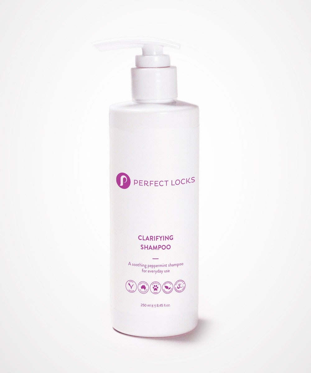 A white bottle of Perfect Locks Perfect Clarifying Shampoo with a pump, purple text, and icons for vegan, cruelty-free, daily use, and hair extensions care.