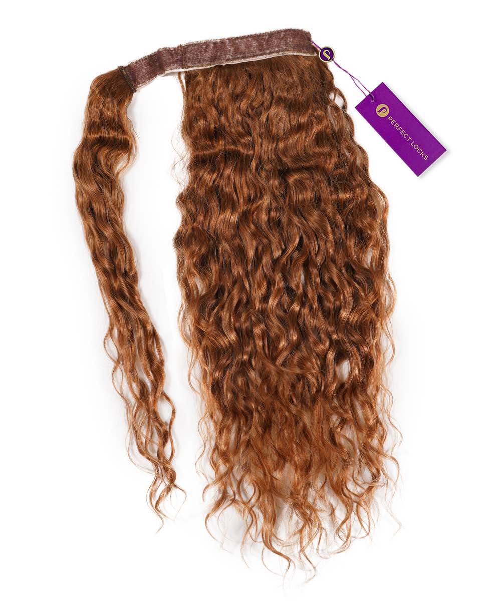 A single Curly Clip-In Ponytail Extension by Perfect Locks in Golden Brown , with a brown band and purple tag on white background.#color_golden-brown-(6)