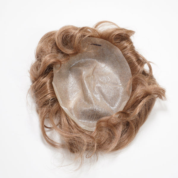 The Perfect Locks Wavy Men's Unit in Light Ash Honey Blonde is shown upside down on a white background, revealing its sheer, circular base and wavy hair around the edges.