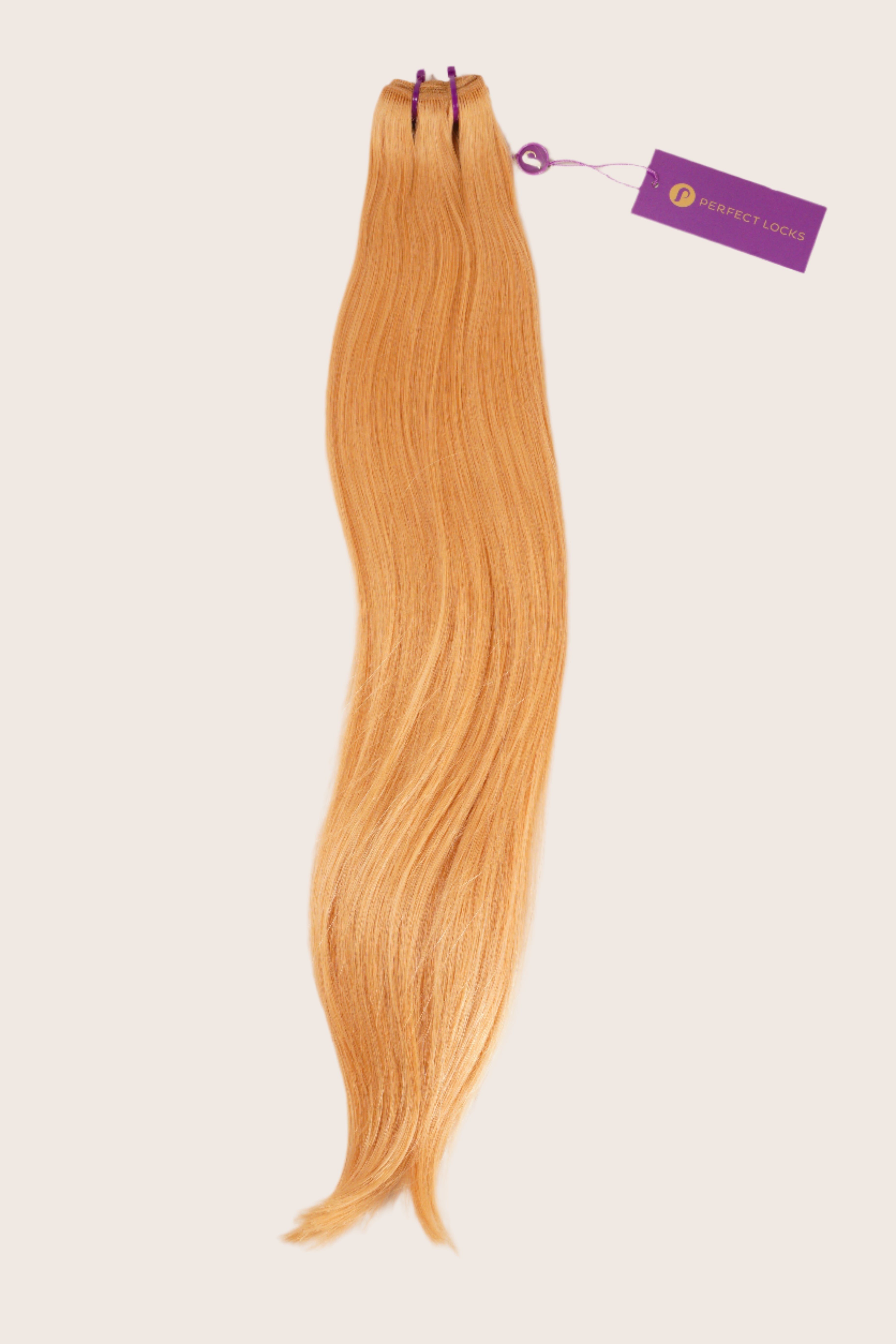 A bundle of long, straight, light ginger-blonde hair extensions tied at the top with purple bands and a Perfect Locks tag attached.