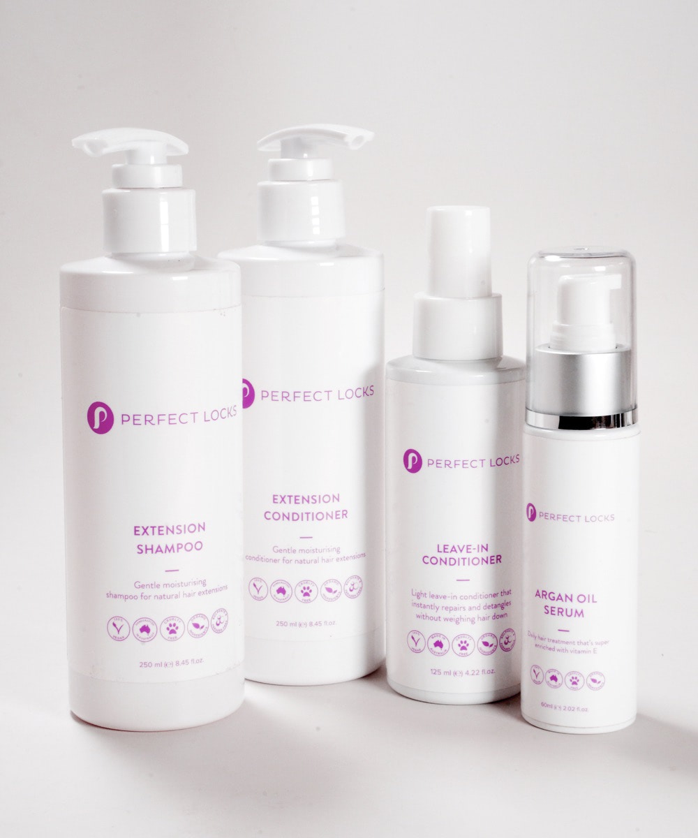 Four white Perfect Locks Hair Extension Care Bundle bottles with purple text, including shampoo, conditioner, leave-in conditioner, and argan oil serum for Remy hair extensions.