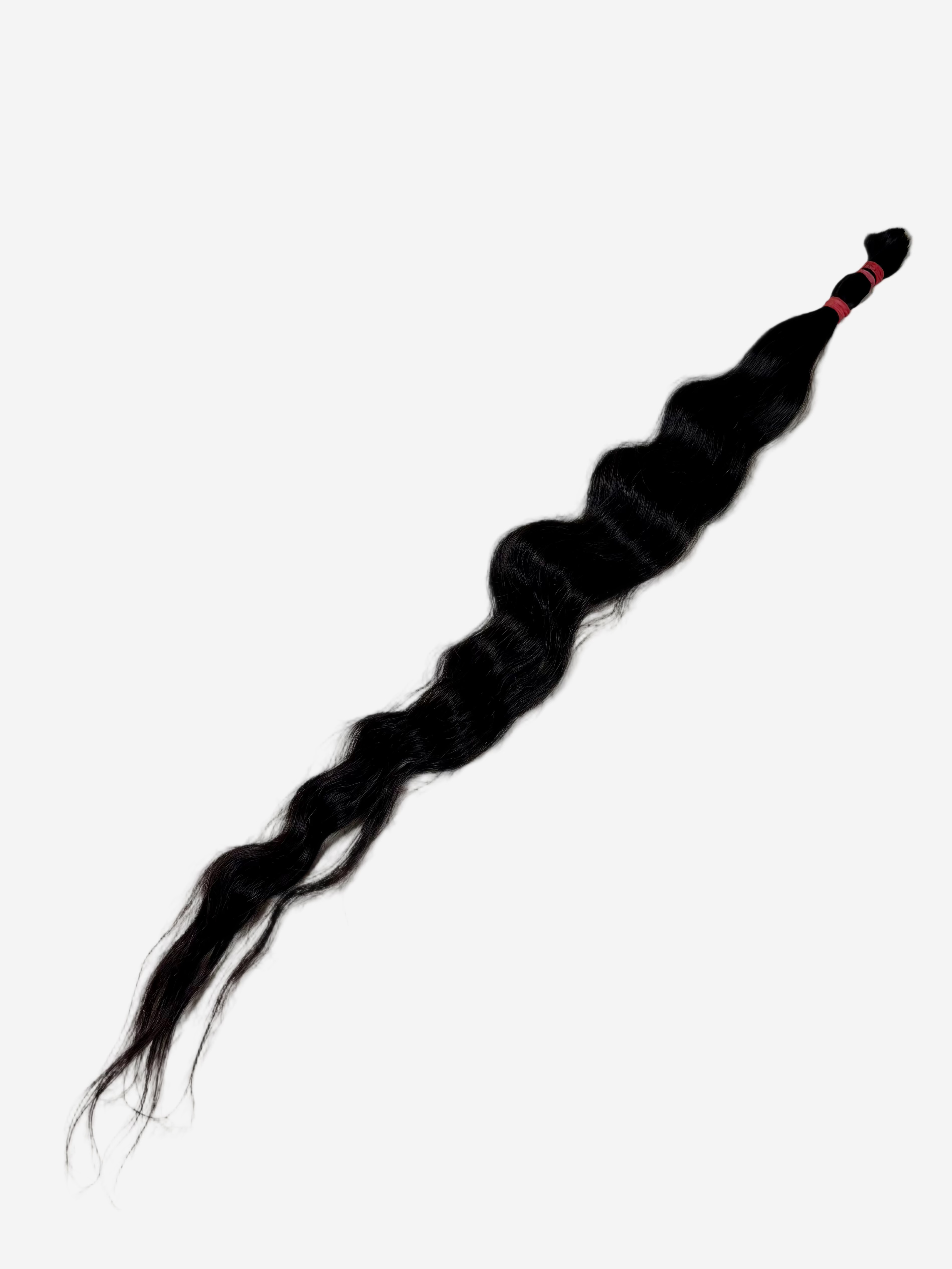 A single long, wavy black hair extension bundle tied at one end with a red band, perfect for adding length and volume.
