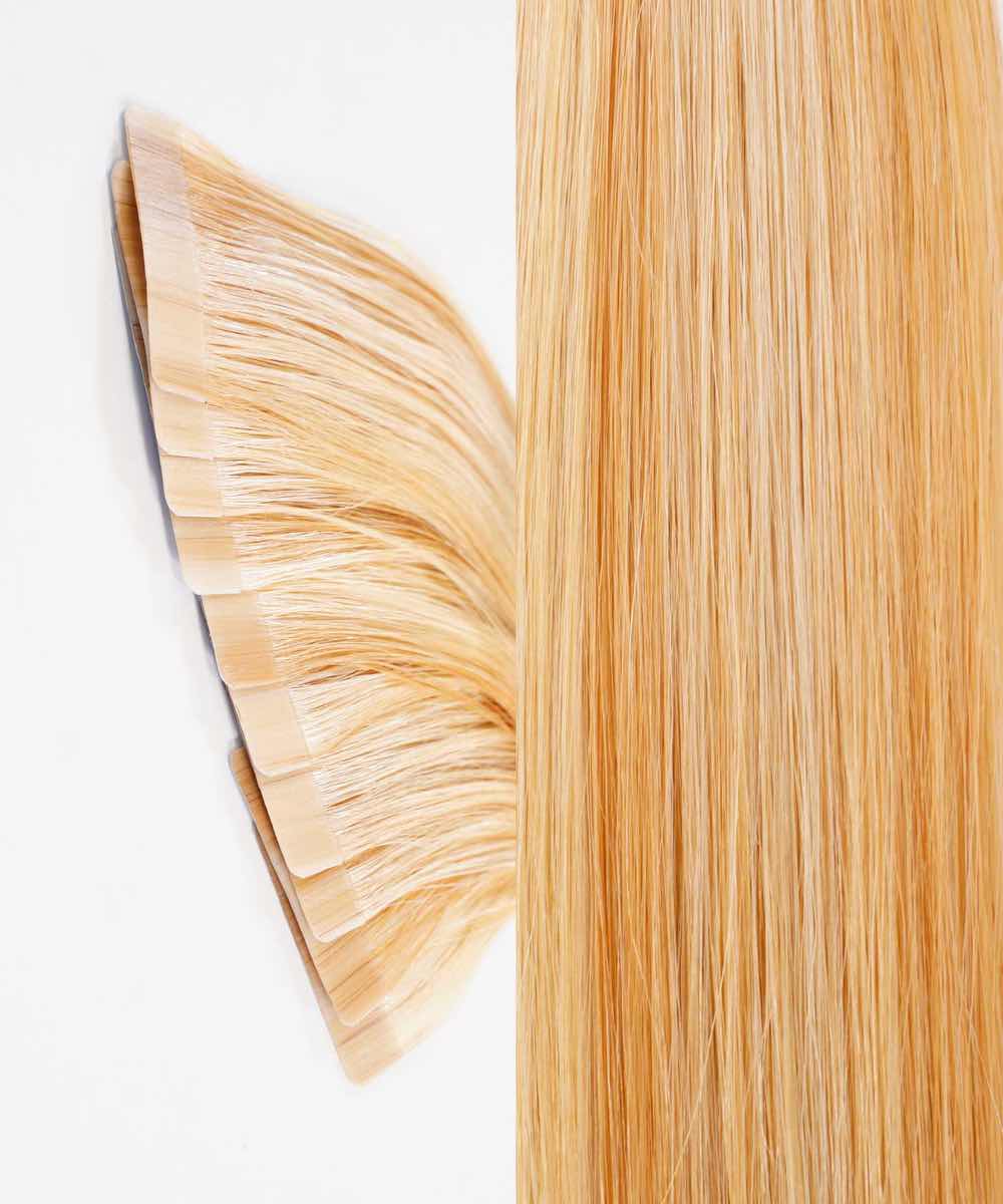 Perfect Locks Straight Classic Tape-In Hair Extensions in caramel blonde highlights on a white surface, tape tabs left, strands right.#color_caramel-blonde-highlights-(24/27/613)