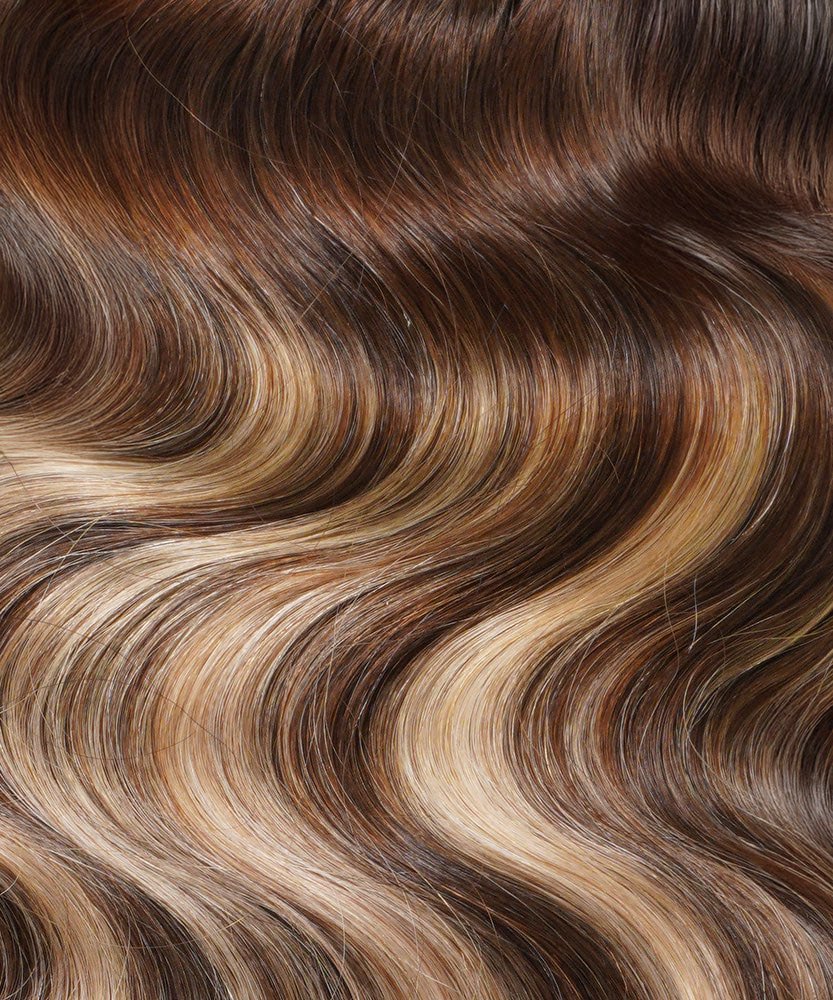 Close-up of Perfect Locks Wavy Seamless Clip-In Hair Extensions in rooted toffee blonde highlights, with soft, shiny waves.#color_rooted-toffee-blonde-highlights-(4/27/4)