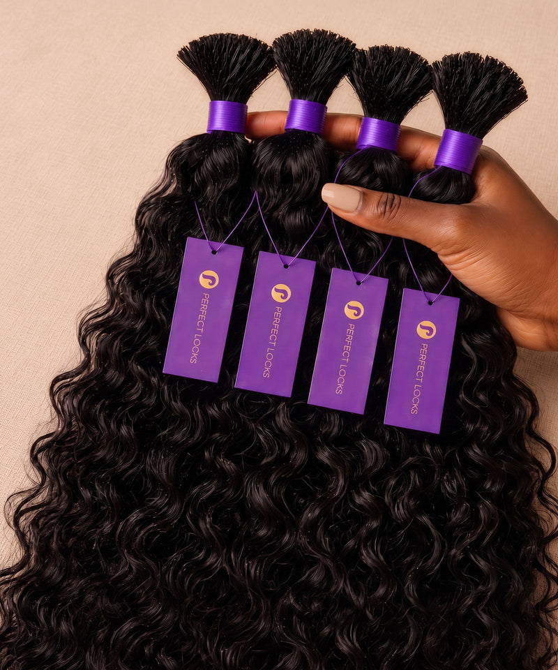 Hand holding four curly natural black bulk braiding hair bundles tied with purple bands and Perfect Locks tags