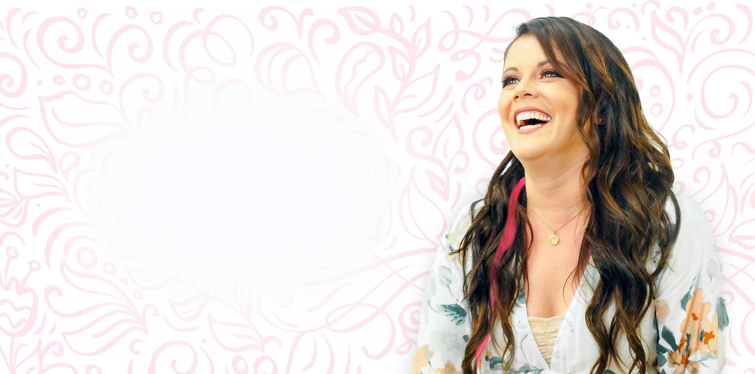 A smiling woman with long, wavy brown hair in a floral top stands before a pink background; left side blank for text or design.