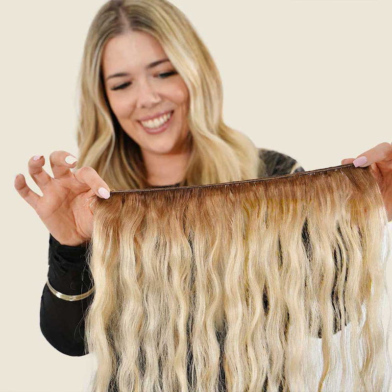 hair stylist holding hand-tied weft