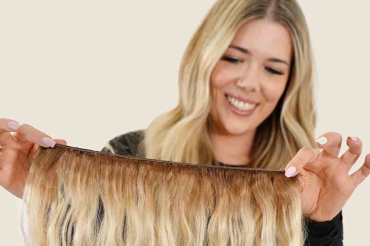 hair stylist holding hand tied weft