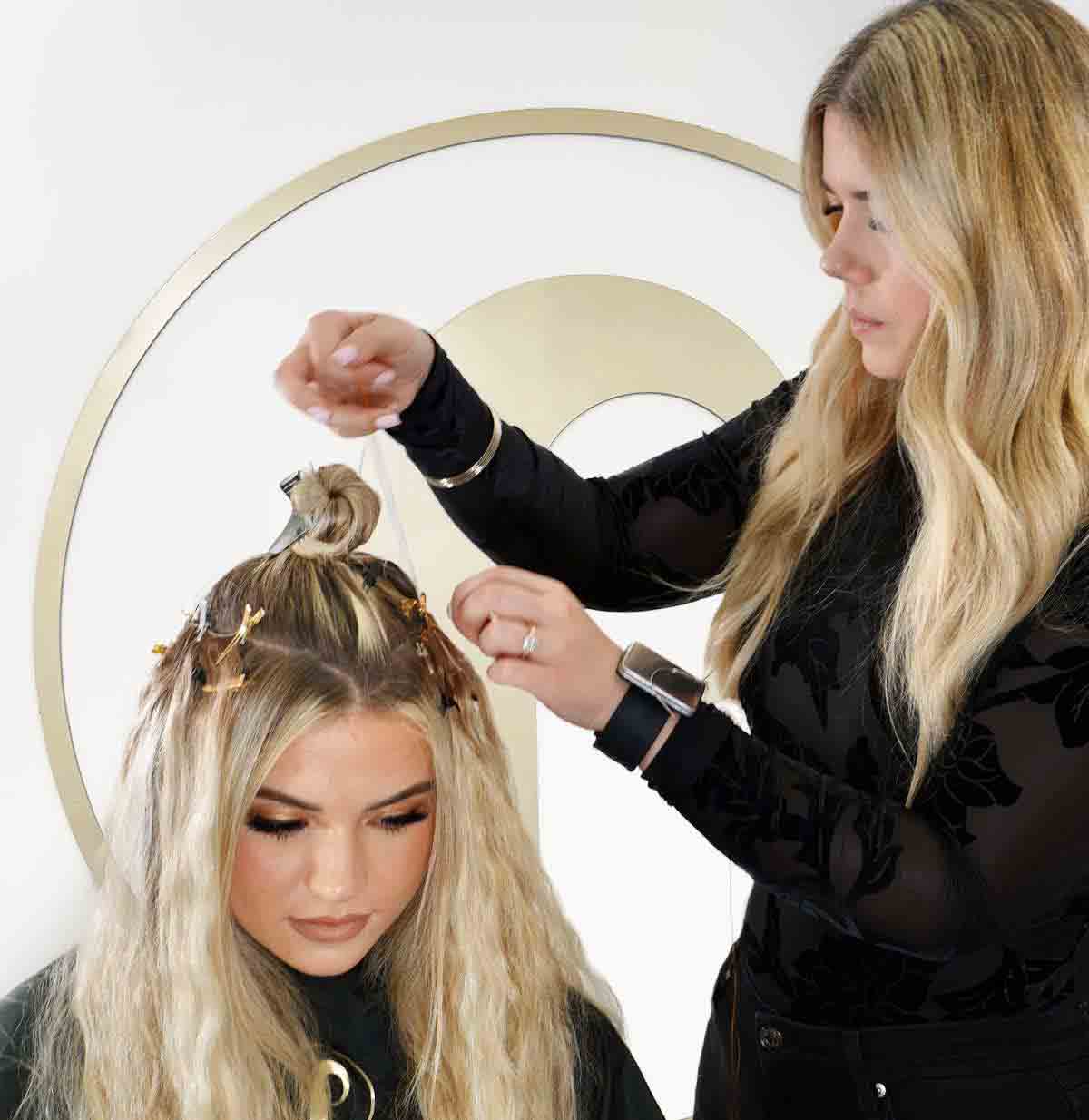 Hair Stylist Installing Hair Extensions