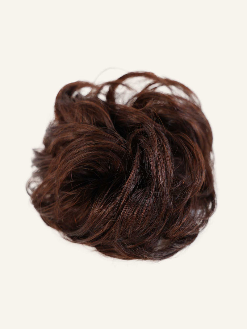 Rich Brunette (2B) human hair scrunchie extension in a dimensional brunette shade with warm caramel undertones, soft layered texture, and natural shine on a clean light studio background.#color_rich-brunette-(2B)