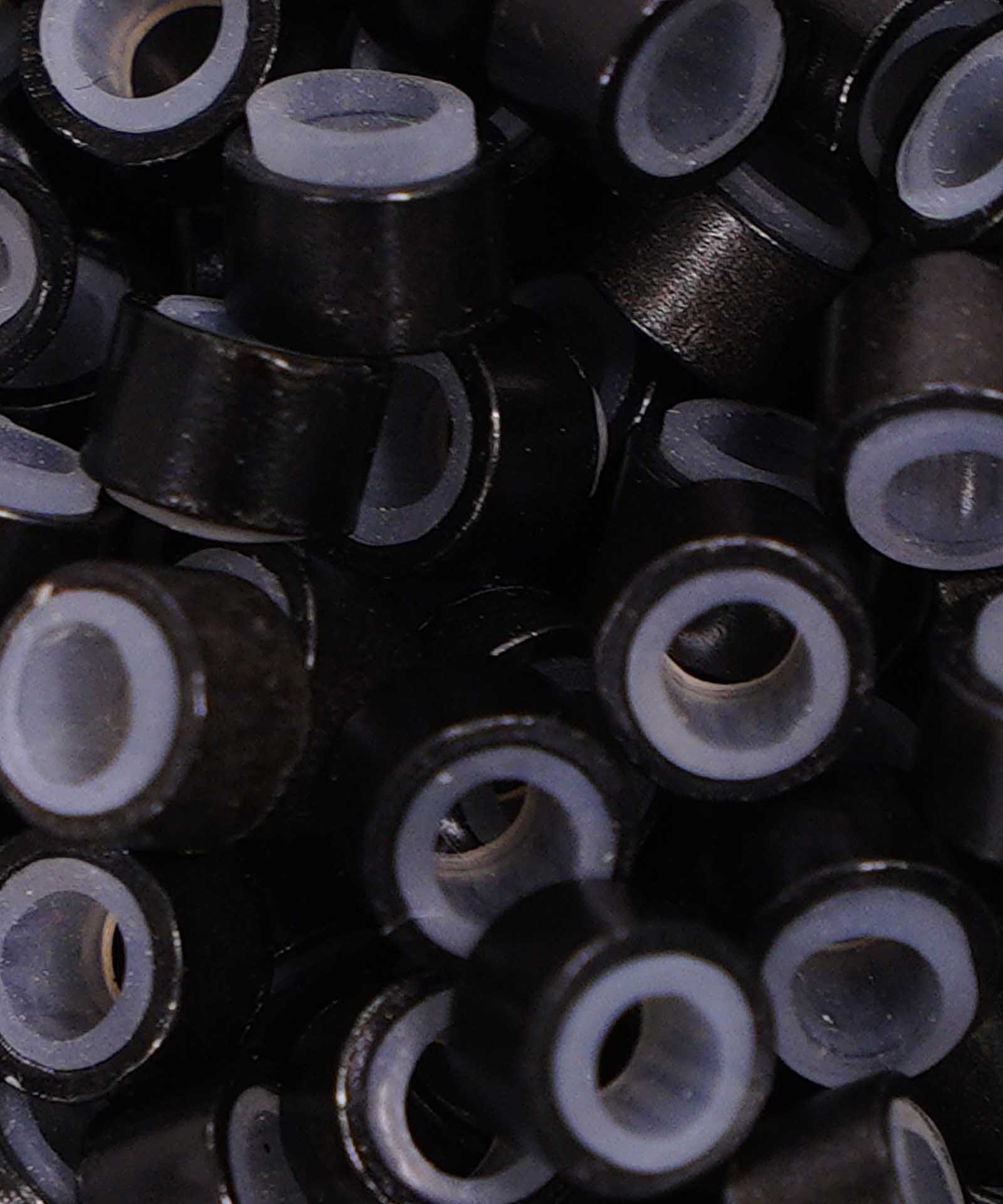 Close-up of Perfect Locks Fusion Micro Ring Beads in dark brown , small gray-ringed cylinders densely packed for hair extensions.#color_jet-black-(1)