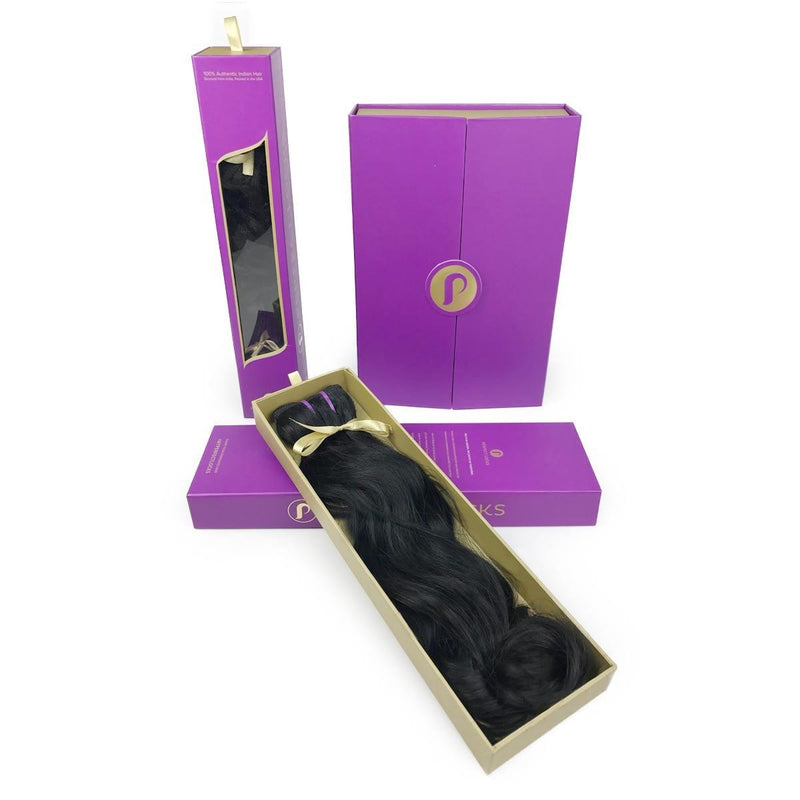 The Perfect Locks Gift Wrapping includes Remy hair extensions in a gold-trimmed box with a purple lid and two closed purple boxes.