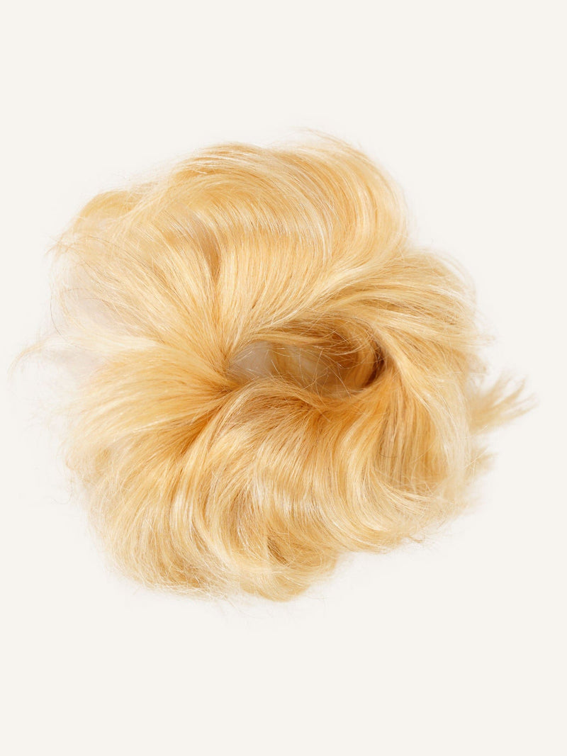 The Perfect Locks Scrunchie Hair Extensions in golden blonde, a fluffy circular synthetic fur scrunchie on a plain white background.#color_golden-blonde-(613)