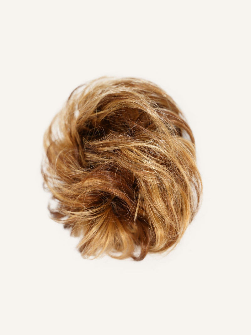 The Perfect Locks Scrunchie Hair Extensions, in warm brown highlights, styled in a loose circular bun against a plain white background.#color_warm-brown-highlights-(6/613)