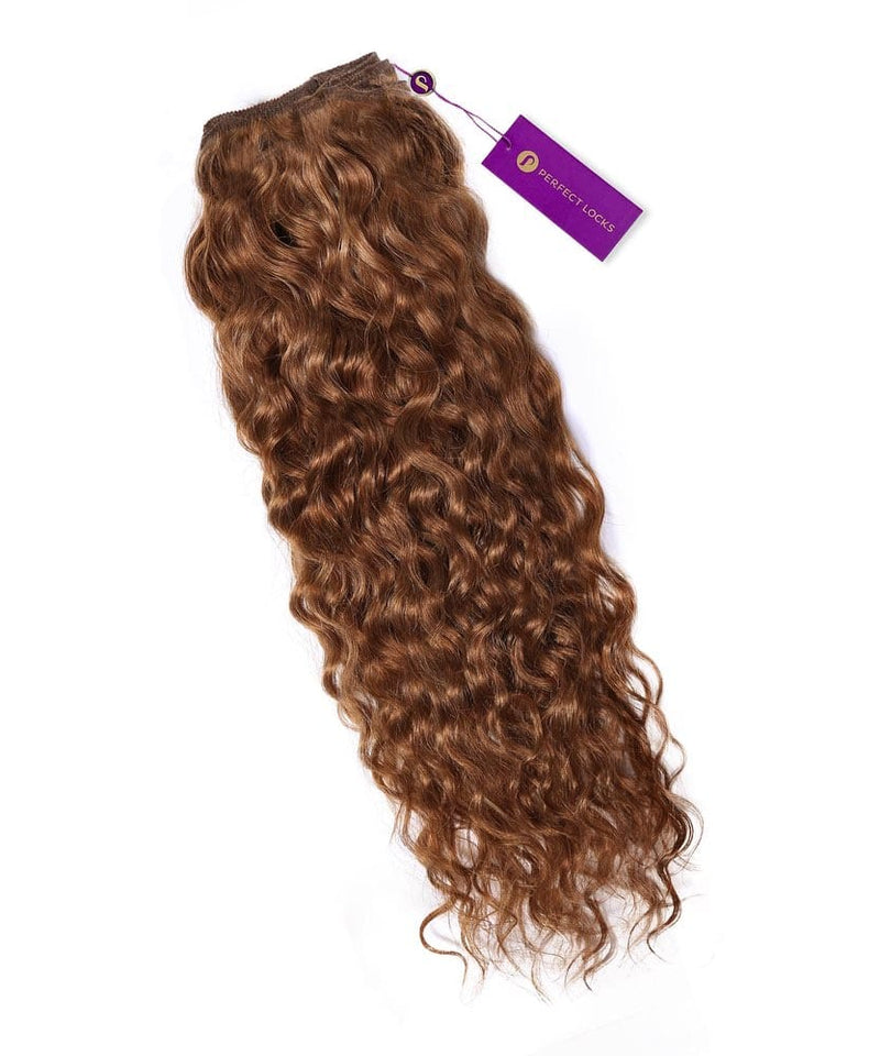 A bundle of Perfect Locks Curly Colored Hair Machine Weft extensions in golden brown with a sewn weft and purple tag on white background.