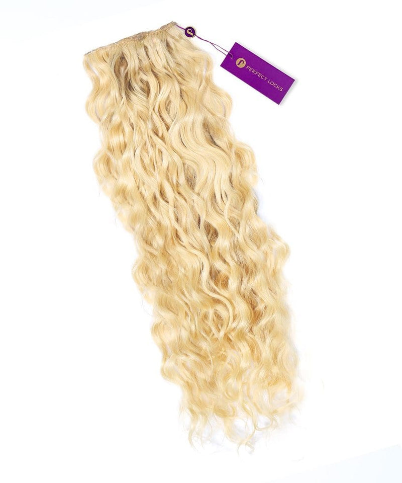 A bundle of platinum blonde Curly Colored Hair Machine Weft by Perfect Locks with a purple tag cascades neatly on a white background.