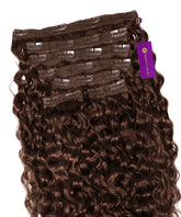 The Perfect Locks Curly Classic Clip-In Hair Extensions in Chocolate Brown  are displayed against a white background, with a purple tag attached to one section.#color_chocolate-brown-(3)