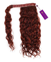 A Curly Clip-In Ponytail Extension by Perfect Locks in Dark Auburn  on a white background, with a sewn top band and attached purple product tag.#color_dark-auburn-(33)