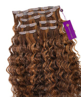 A set of Curly Seamless Clip-In Hair Extensions by Perfect Locks in highlighted brown auburn, with labeled pieces and a purple tag.#color_highlighted-brown-auburn-(30/31/33)