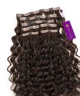Curly Seamless Clip-In Hair Extensions from Perfect Locks in Natural Black fanned out, with a purple tag on one clip.#color_natural-black-(1B)