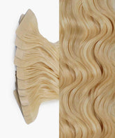 Perfect Locks Curly Classic Tape-In Hair Extensions in Rooted Cocoa Ash Blonde (18/60), adhesive tape tabs left, loose waves right.#color_ash-blonde-(60)