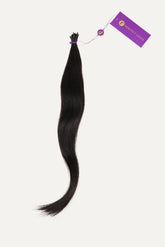 A bundle of long, straight black hair tied at the top with a purple Perfect Locks tag attached by a string.