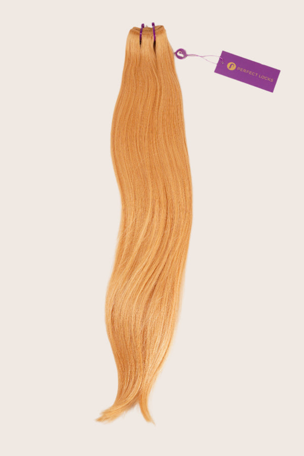 A bundle of long, straight, light ginger-blonde hair extensions tied at the top with purple bands and a Perfect Locks tag attached.