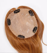 The Perfect Locks Straight Topper in Golden Brown is 16 inches long with a 6 by 6.5 inch base and features four black clips underneath to attach securely to natural hair.