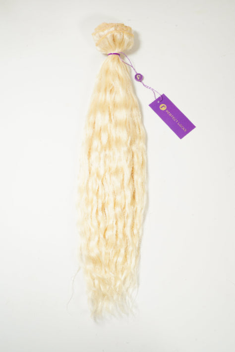 Platinum blonde, wavy hair extensions tied at the top with a purple band and tag, displayed on a white background.