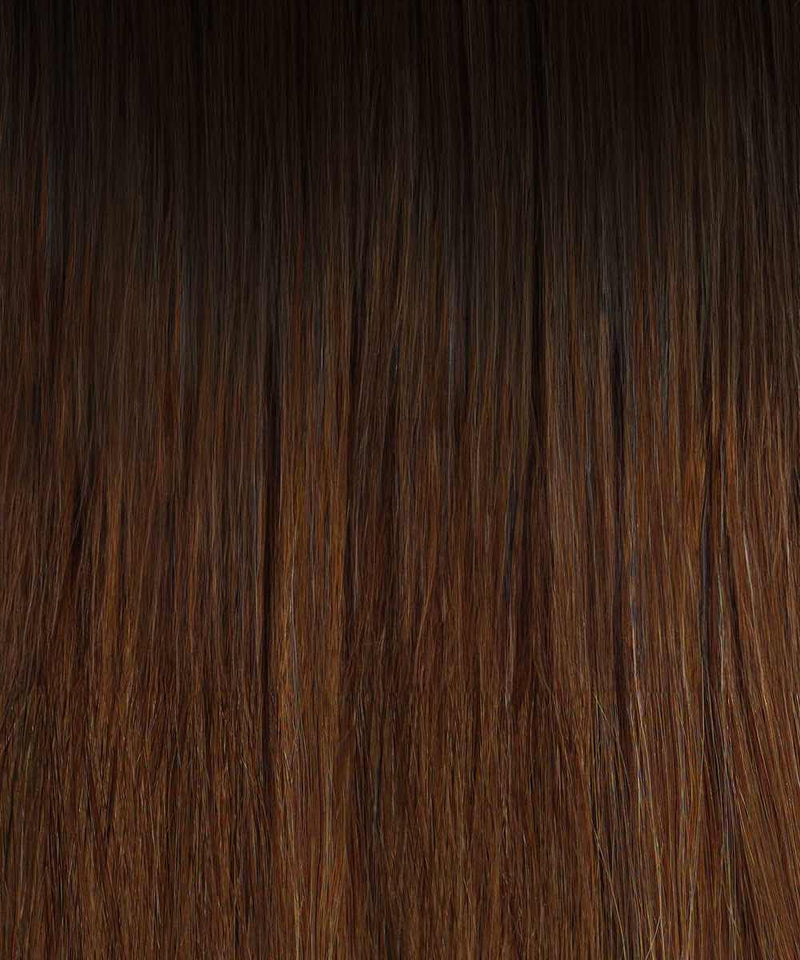 Close-up view of straight, smooth rooted caramel blonde hair with subtle highlights and natural shine, showcasing hair extensions.