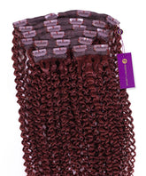 A bundle of Perfect Locks Kinky Curly Classic Clip In Hair Extensions in Dark Auburn arranged neatly with a purple tag.#color_dark-auburn-(33)