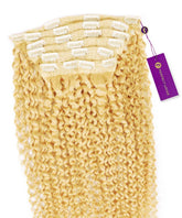 A set of Perfect Locks Kinky Curly Classic Clip In Hair Extensions in platinum blonde with white clips and a purple tag, stacked neatly.#color_platinum-blonde-(613)