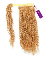 The Kinky Curly Clip-In Ponytail Extensions by Perfect Locks with honey blonde Remy coils, yellow weft, purple tag on white.#color_honey-blonde-(27)