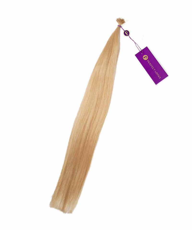 A bundle of Straight Fusion I-Tip Hair by Perfect Locks in Golden Brown , tied at the top with a purple tag attached.