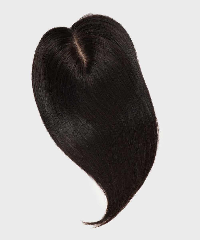A Perfect Locks Straight Human Hair Crown Topper in natural black styled in a heart shape on a plain light background.