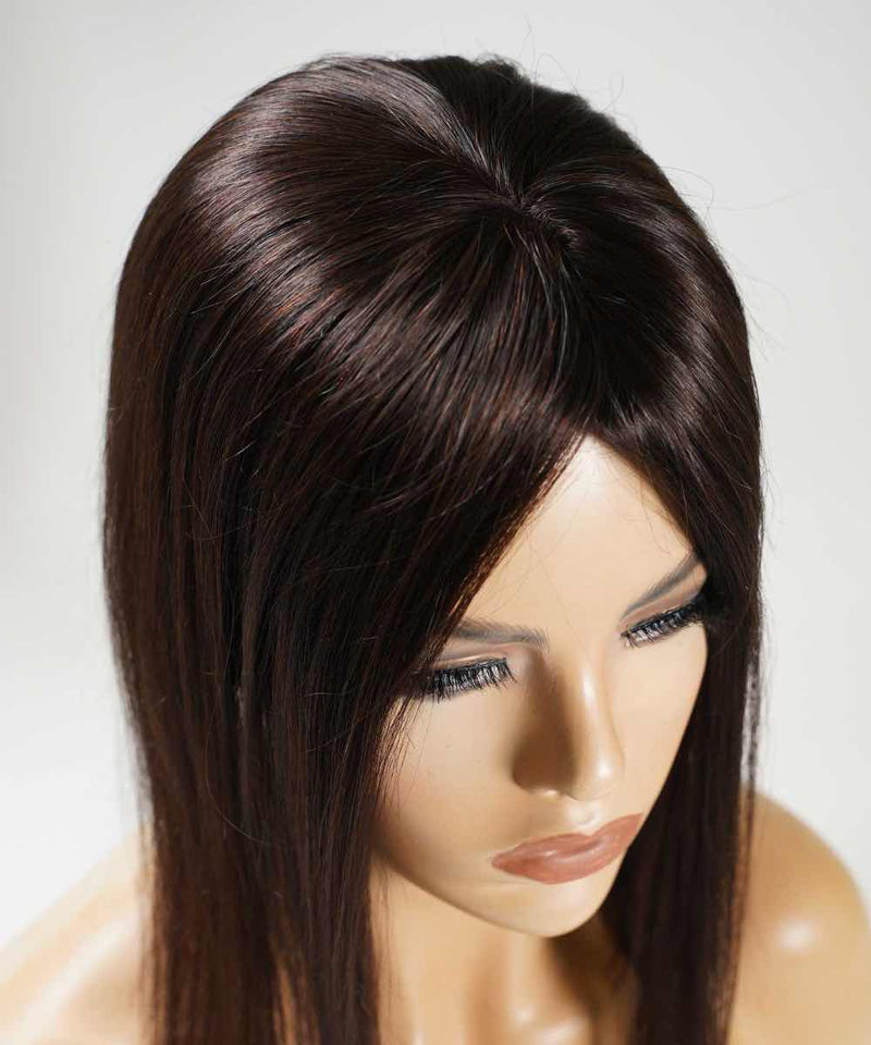 The Perfect Locks Straight Human Hair Crown Topper in dark brown on a mannequin with long eyelashes, seen from a high angle against a light background.