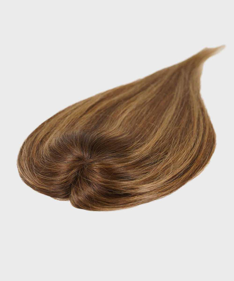 A Perfect Locks Straight Human Hair Crown Topper in toffee blonde highlights styled teardrop shape on white, hair smoothly twisted at base.