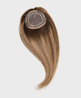 The Perfect Locks Straight Human Hair Crown Topper in toffee blonde highlights with mesh base and clips on a white background.#color_toffee-blonde-highlights-(4/27)