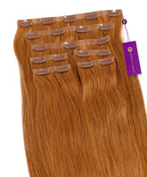 Highlighted Pearl Blonde (8/26/613) Straight Seamless Clip-In Hair Extensions by Perfect Locks with clips and a purple tag.#color_golden-brown-(6)