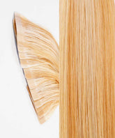 Perfect Locks Straight Classic Tape-In Hair Extensions in caramel blonde highlights on a white surface, tape tabs left, strands right.#color_caramel-blonde-highlights-(24/27/613)