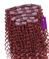 A bundle of Dark Auburn Tight Curly Classic Clip-In Hair Extensions by Perfect Locks, with multiple wefts and attached clips, featuring a branded tag.#color_dark-auburn-(33)